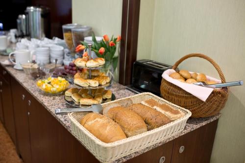 a table topped with cakes and pastries at Hotel Justyna in Krakow