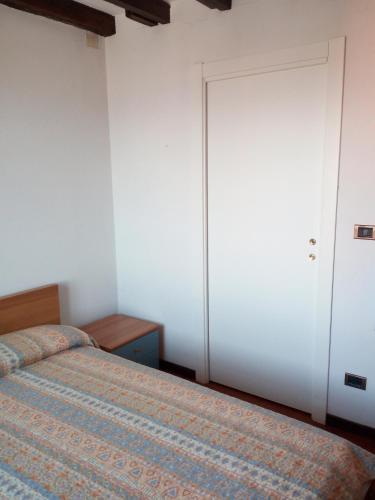 a bedroom with two beds and a closet at Casa Picasso in Genova