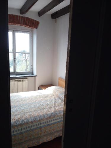a bedroom with a bed and a window at Casa Picasso in Genova