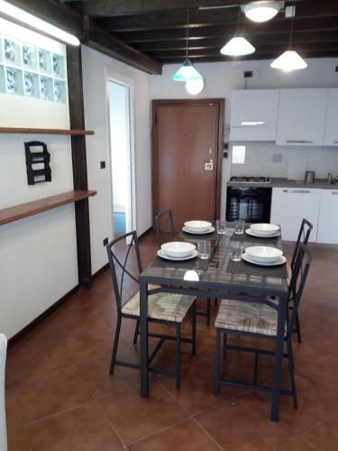 a dining room with a black table and chairs at Casa Picasso in Genova