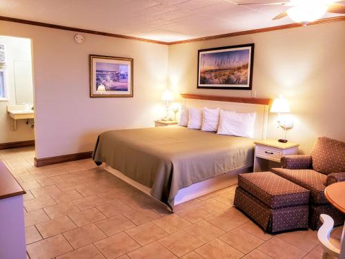 a hotel room with a bed and a chair at Avondale by the Sea in Cape May