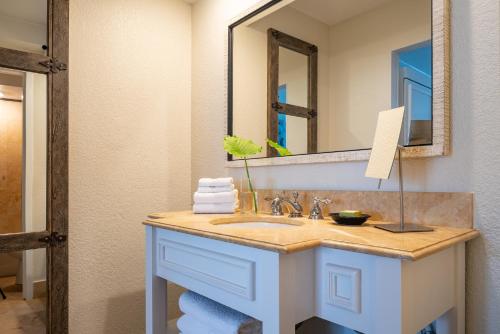 a bathroom with a sink and a mirror at Havana Cabana at Key West in Key West