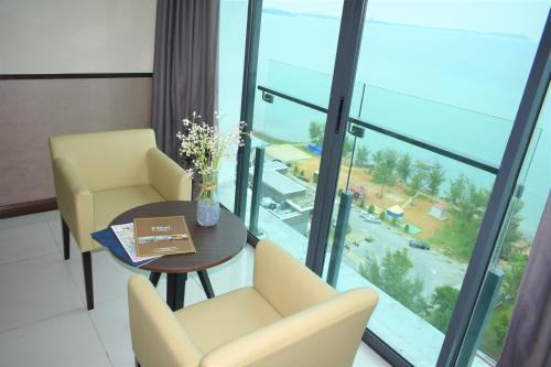 a room with a table and chairs and a large window at D'Wharf Hotel & Serviced Residence in Port Dickson