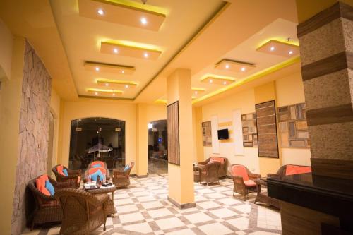 a lobby with chairs and tables in a building at Majorica Marina Hotel in El Alamein