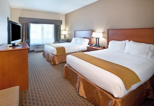 a hotel room with two beds and a flat screen tv at Holiday Inn Express & Suites Sioux Falls Southwest, an IHG Hotel in Sioux Falls