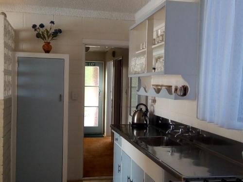 a kitchen with a sink and a counter top at Redwood Lodge Motel in Levin