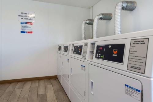 a row of washers and dryers in a laundry room at Motel 6-Greenville, SC in Greenville