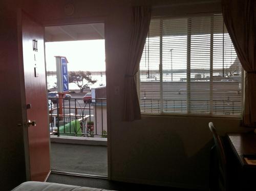 a room with a window with a view of a playground at Bayfront Inn in Morro Bay