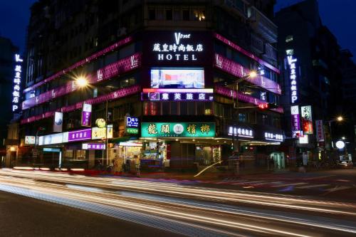 a building with neon signs in a city at night at V-one Vogue Hotel in Taipei