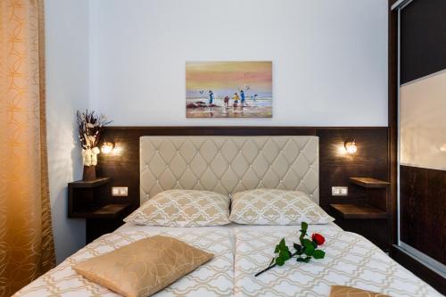 a bedroom with a bed with a white bedspread at Villa Aria in Malinska