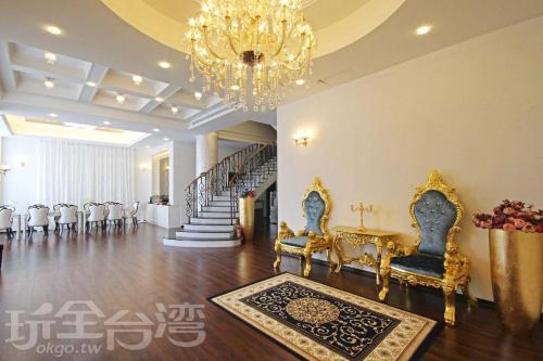 a large room with chairs and a chandelier at Moly Homestay in Jiaoxi