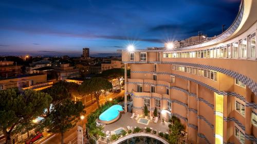 an aerial view of a hotel at night at Savoia Hotel Rimini in Rimini
