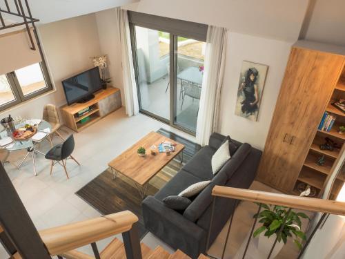 Dempla Heights Villas في تافرونيتيس: غرفة معيشة مع أريكة وطاولة