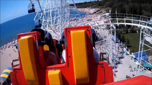 a carnival ride with a ferris wheel in the background at Guest House Parus in Bosteri