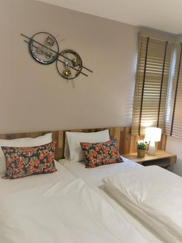 a bedroom with a bed and a clock on the wall at Bangkok Saran Poshtel in Bangkok