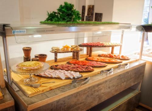 a display case with many different types of food at Hotel Spa El Muelle de Suances in Suances