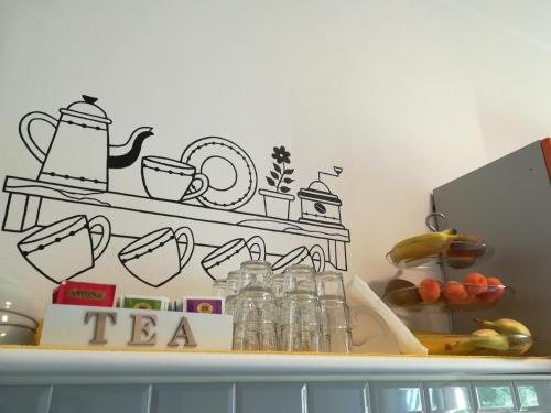 a shelf with a tea kettle and cups on it at Lo Zizzolo- Bed&Breakfast in Marina di Campo