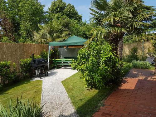 un giardino con tavolo da picnic e gazebo di KEI apartment a Portoroz