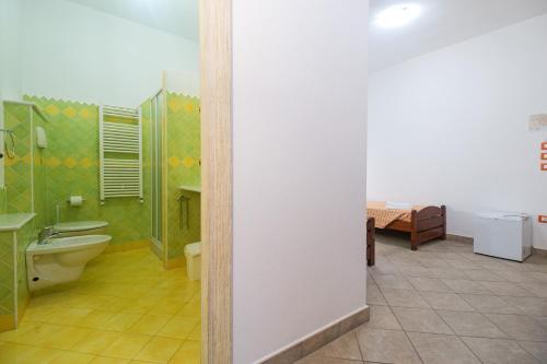 a bathroom with a toilet and a sink at Melalidone in Orosei