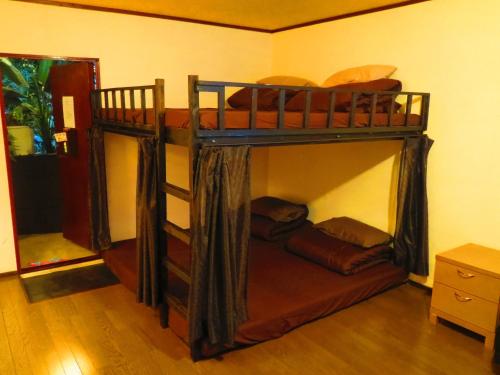 a bedroom with two bunk beds in a room at Stella Resort in Naha