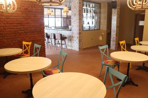 a room with tables and chairs and a brick wall at Swosti Chilika Resort in Kānāipur