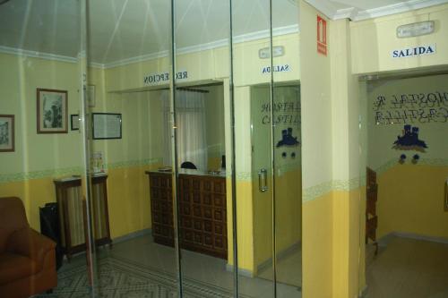 a room with glass doors in a building at Hostal Residencia Castilla in Cuenca