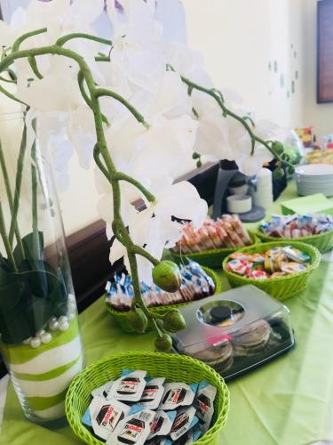 a table with food and a vase with flowers at Green Park Hotel & Residence in Bagnara Calabra