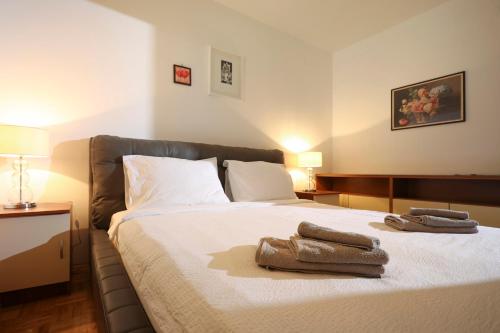 a bedroom with a bed with two towels on it at Vrata Jadrana in Rijeka