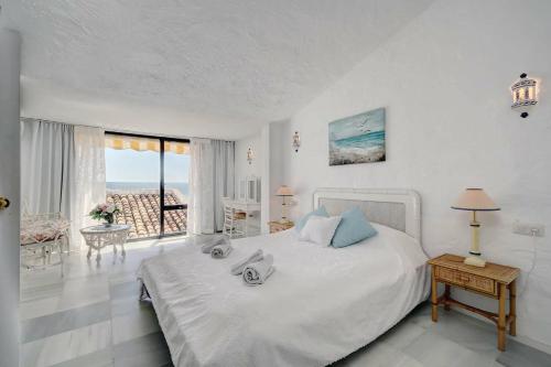 a bedroom with a bed with a view of the ocean at Sea shells at Bahia Dorada in Estepona