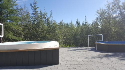 a bath tub sitting next to a pool of water at Hotel Kjarnalundur in Akureyri