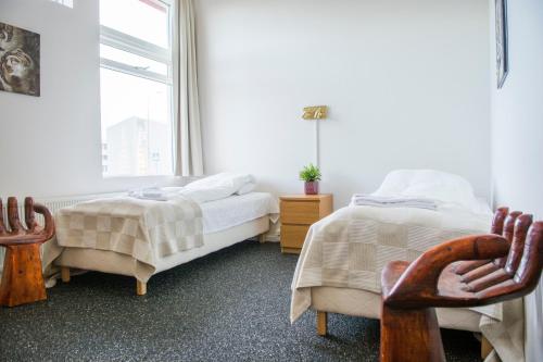 a bedroom with two beds and a window at Höfn Inn Guesthouse in Höfn