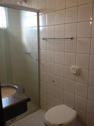 a bathroom with a shower and a toilet and a sink at Hotel Central in Porto Velho
