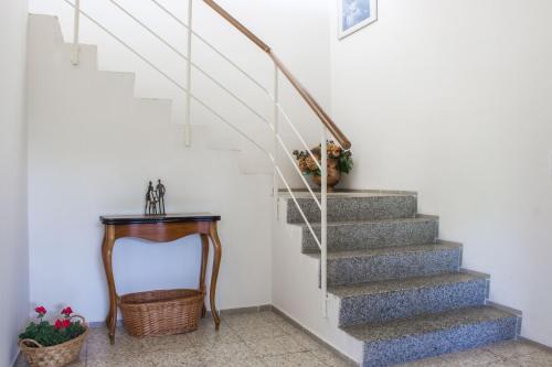 a stairway with a vase of flowers and a table at Vila Les Kralovstvi in Nemojov