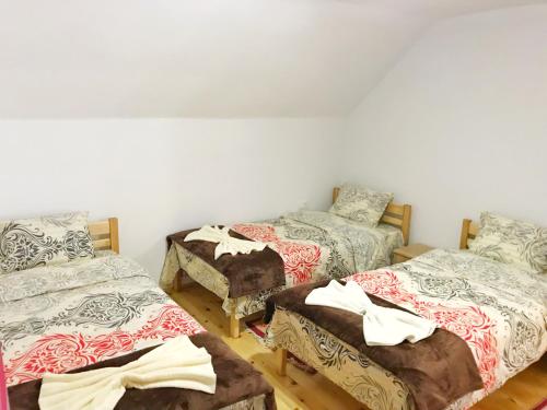 a room with three beds in a room at Chalet Kujta in Peje