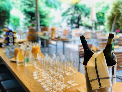 a table with wine bottles and glasses on it at Hotel Felmis in Luzern