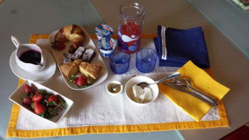 un tavolo con un piatto di cibo e un cesto di frutta di Casa dolce casa a Pienza