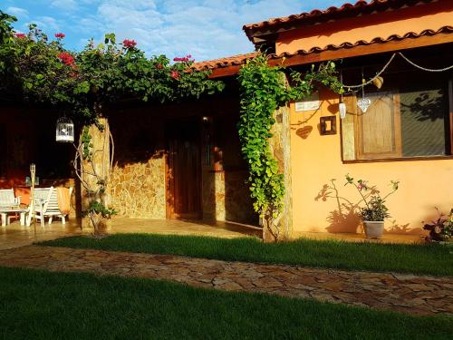 a house with a patio and a table and chairs at Casa Dos Patos in Flecheiras