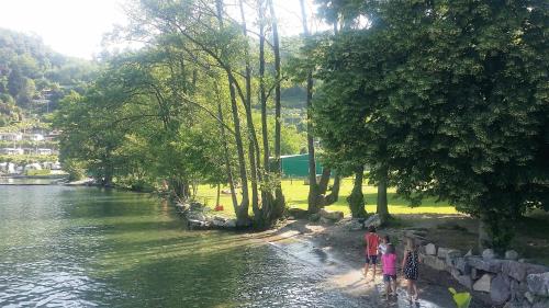 a group of people walking along a river at Casa Allegra in Orta San Giulio