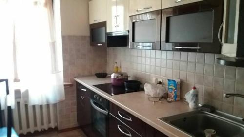 a kitchen with a sink and a counter top at Аркадия Флэт in Odesa
