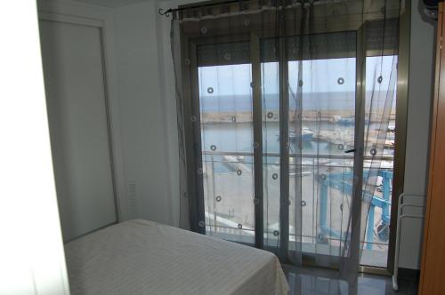 a bedroom with a window with a view of an airport at Vistas al mar in L'Ametlla de Mar