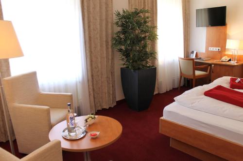 Postel nebo postele na pokoji v ubytování Hotel Ostseeresidenz Cammann Grömitz
