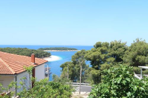 a view of the ocean from a house at Apartments Maras in Primošten