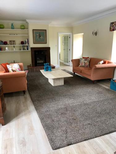 a living room with two couches and a coffee table at Seawell in Towcester