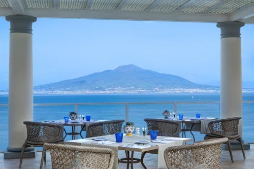 a restaurant with a view of the ocean at Grand Hotel Royal in Sorrento