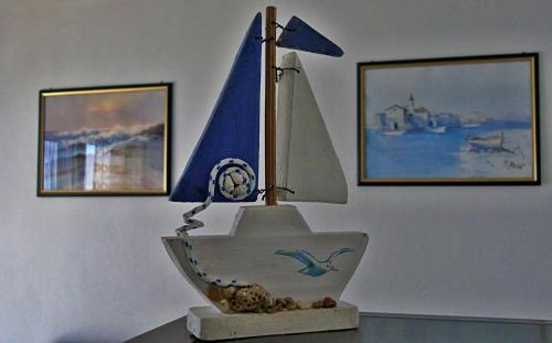 a statue of a boat with a sail on a table at Apartments Purkovic in Vodice