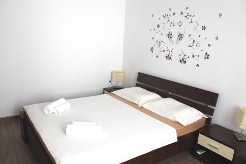 a small bedroom with a bed with white sheets at Apartment Maja in Krk