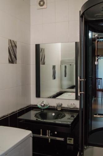 a bathroom with a sink and a mirror at Apartment on Parkova 36 in Chornomorsk