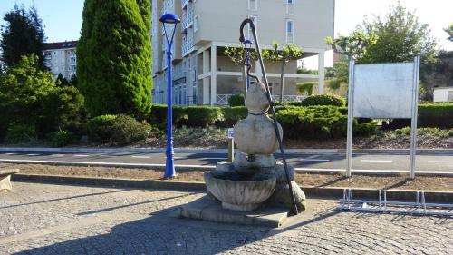 a statue of a woman in a fountain on a street at Hotel A Marisqueira I Aeropuerto A Coruña in Oleiros