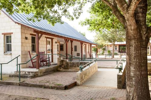 a building with a staircase next to a tree at Gruene Cottages in New Braunfels