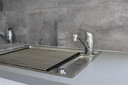 a kitchen sink with two faucets on top of it at les salines de la turballe in La Turballe